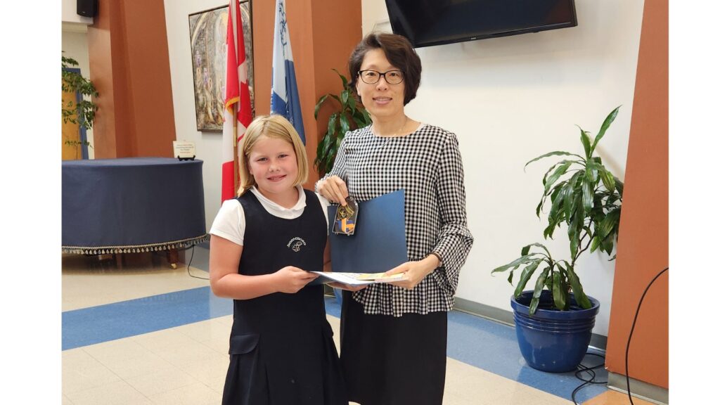 Hawthorn School for Girls teacher stands with lower school student who wins Cursive is Cool Contest