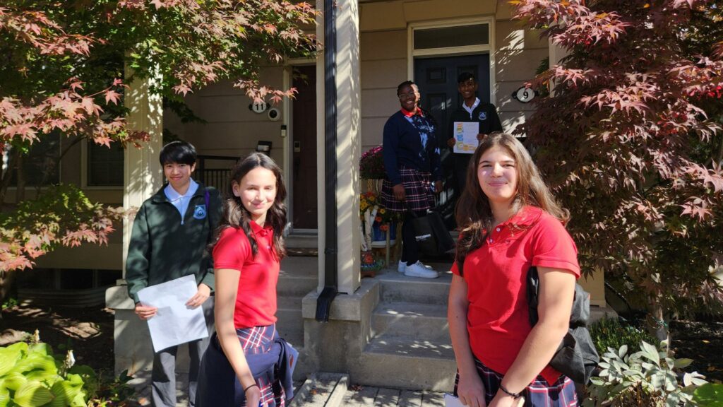 3 Hawthorn School for Girls students door knocking with 2 boys from Crescent School