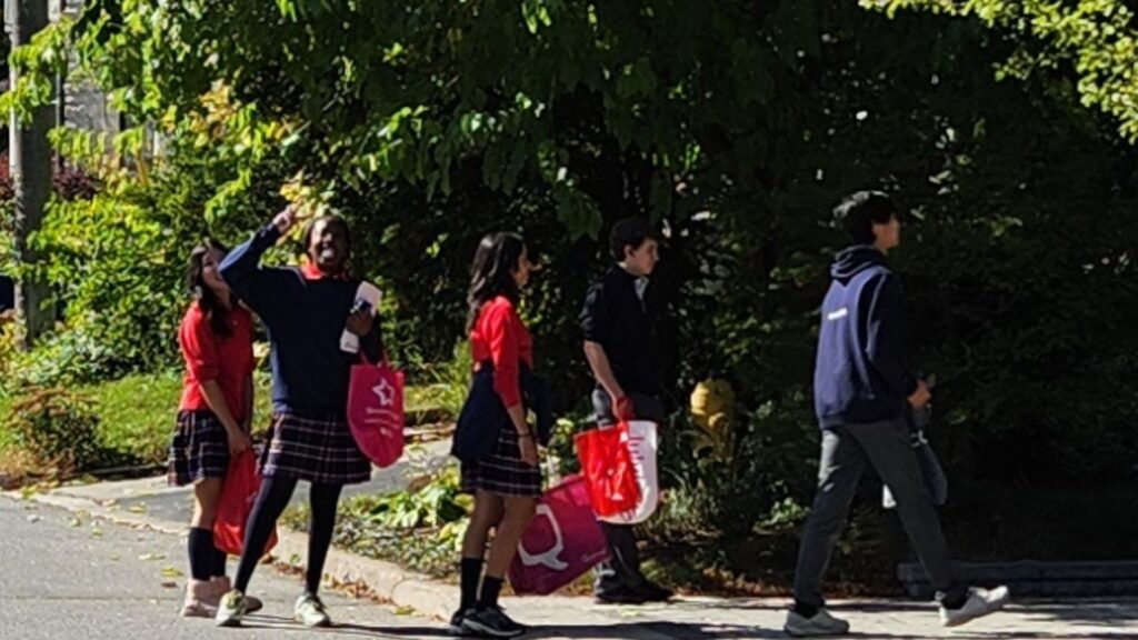 3 Hawthorn School for Girls students with 2 Crescent School students walking up a driveway