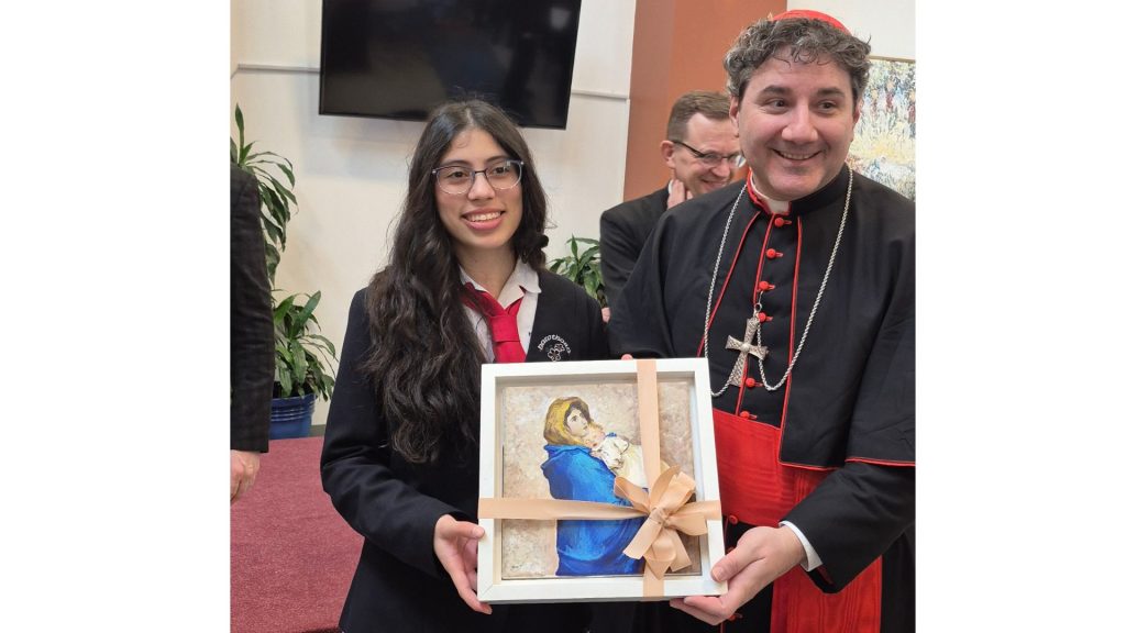Hawthorn School for Girls student presents her painting to the Cardinal