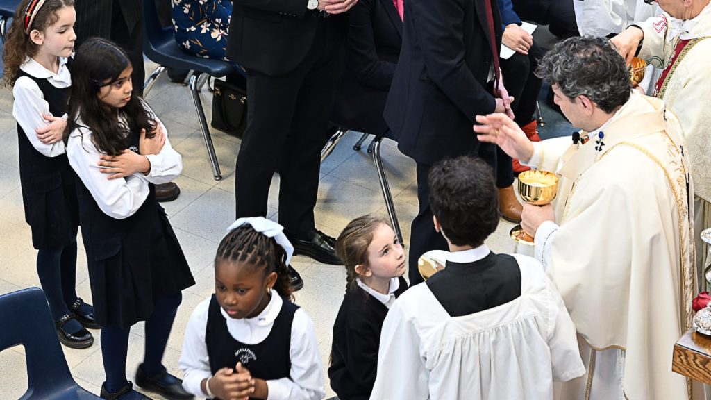 Cardinal Leo distributes communion to children at Hawthorn School for Girls